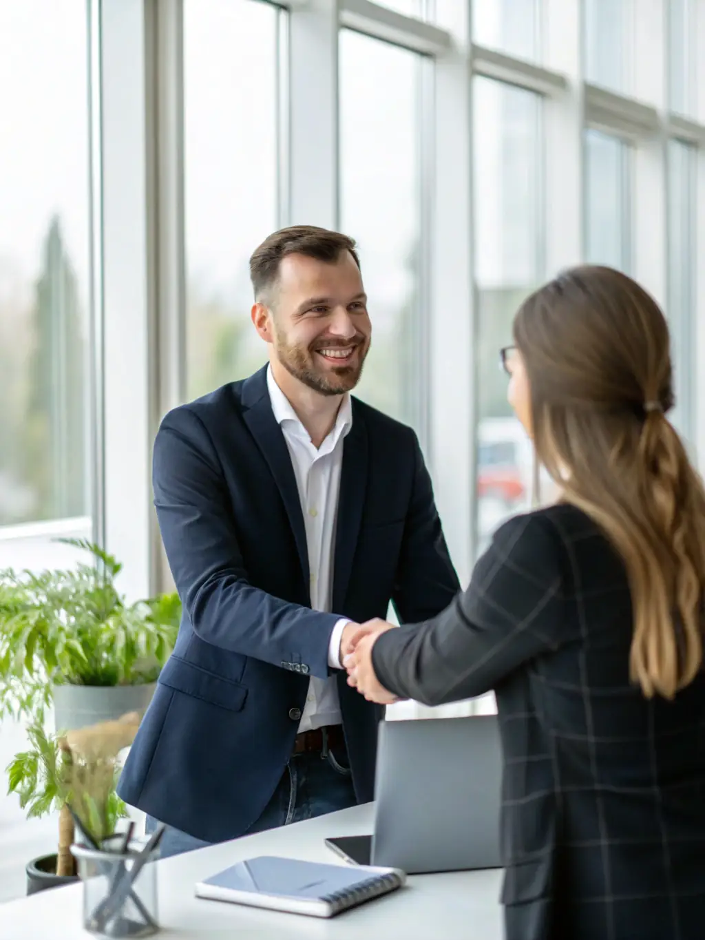 A satisfied client shaking hands with a Legal Innova team member in front of a futuristic office, representing successful client outcomes.
